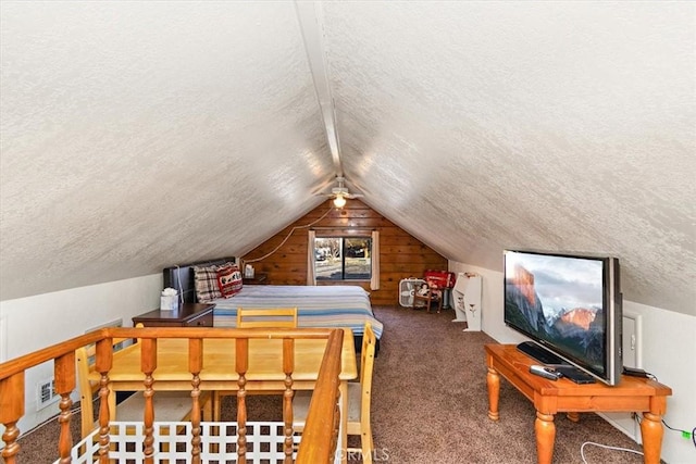 bedroom featuring dark colored carpet, vaulted ceiling, and a textured ceiling