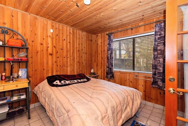 bedroom featuring wood ceiling, wooden walls, and light tile patterned floors