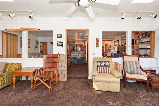 living area featuring carpet and ceiling fan