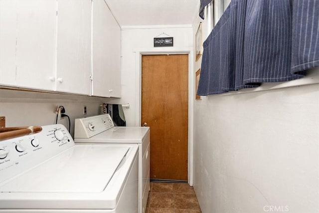 clothes washing area with washer and dryer, cabinet space, and tile patterned floors