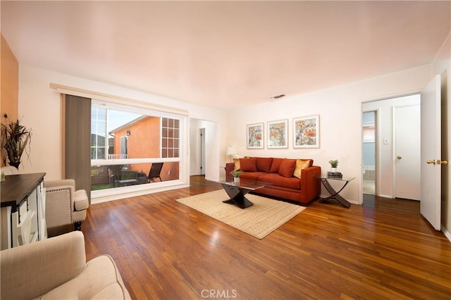 living area featuring dark wood-style floors and visible vents