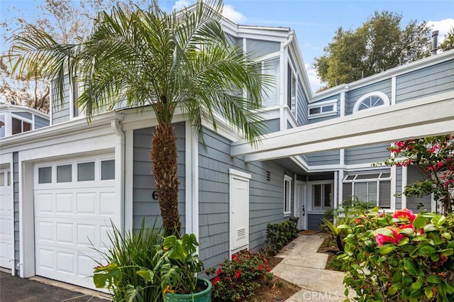 view of side of home featuring an attached garage