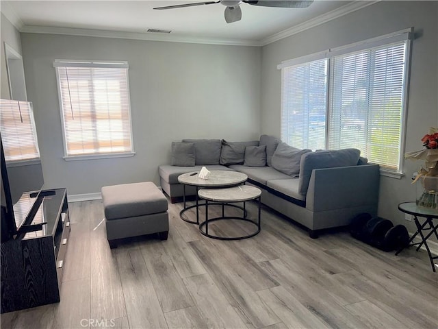 living room featuring visible vents, plenty of natural light, light wood-style floors, and ceiling fan