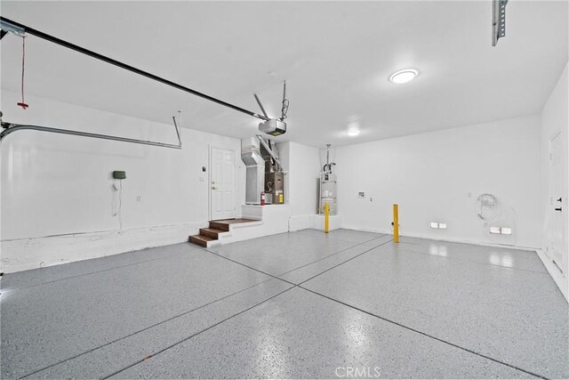 garage featuring heating unit, secured water heater, and a garage door opener