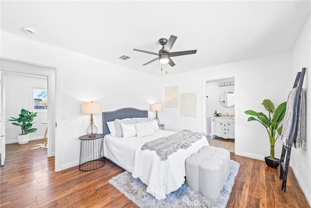 bedroom with a ceiling fan, baseboards, visible vents, and wood finished floors