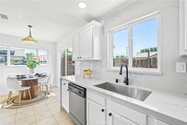 kitchen featuring a sink, white cabinets, dishwasher, tasteful backsplash, and decorative light fixtures