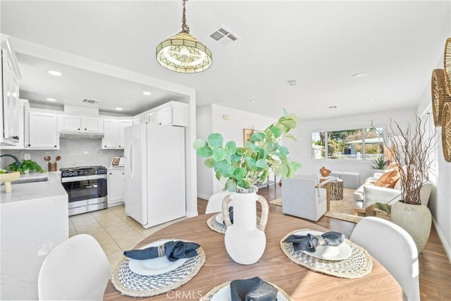 dining space with light tile patterned flooring, visible vents, and recessed lighting