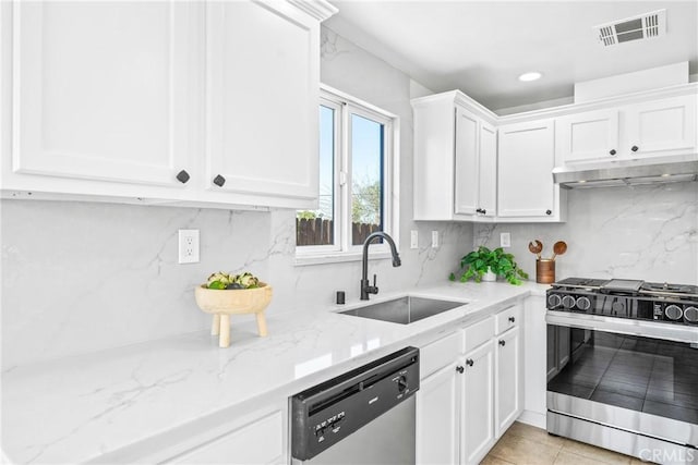 kitchen with under cabinet range hood, stainless steel appliances, a sink, white cabinetry, and visible vents