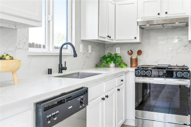 kitchen featuring stainless steel appliances, tasteful backsplash, white cabinets, a sink, and under cabinet range hood