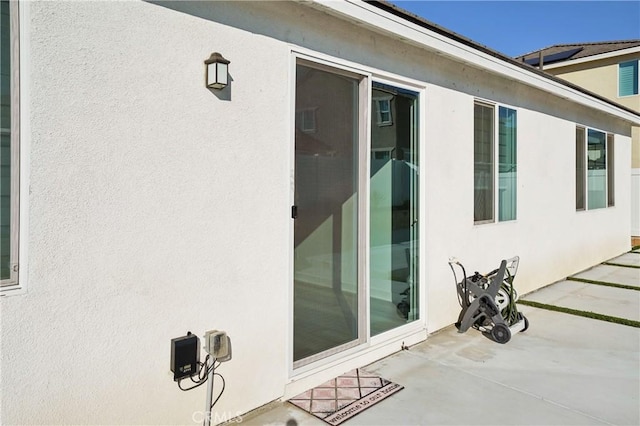 exterior space featuring a patio and stucco siding