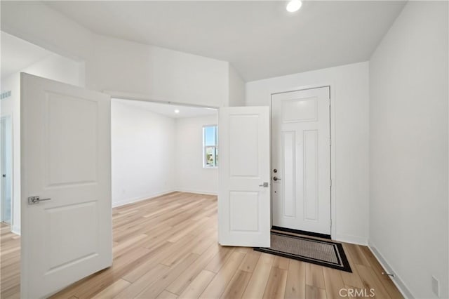 entrance foyer with light wood-type flooring, baseboards, and recessed lighting