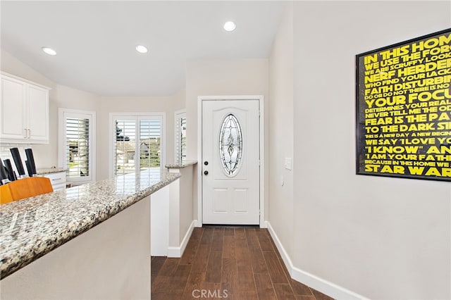 interior space featuring baseboards, dark wood finished floors, and recessed lighting