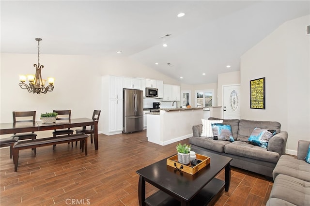 living room featuring vaulted ceiling, dark wood finished floors, visible vents, and a notable chandelier