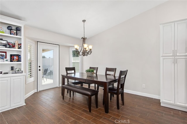 dining room featuring an inviting chandelier, baseboards, and dark wood finished floors