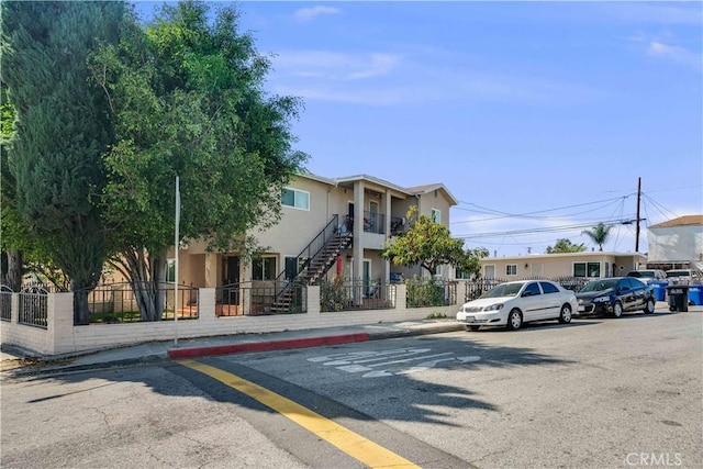 view of street featuring stairway, curbs, and sidewalks