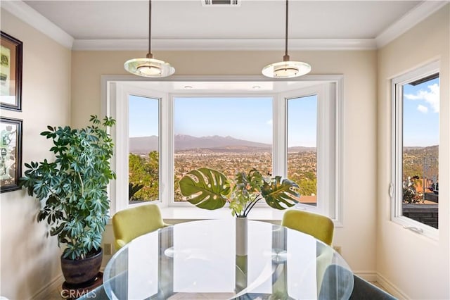 dining area featuring visible vents, a mountain view, and crown molding