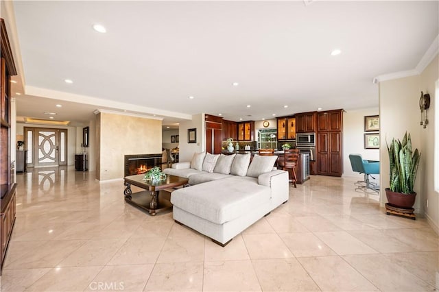 living room with crown molding, recessed lighting, a fireplace, and baseboards