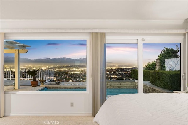 bedroom featuring access to outside and a mountain view