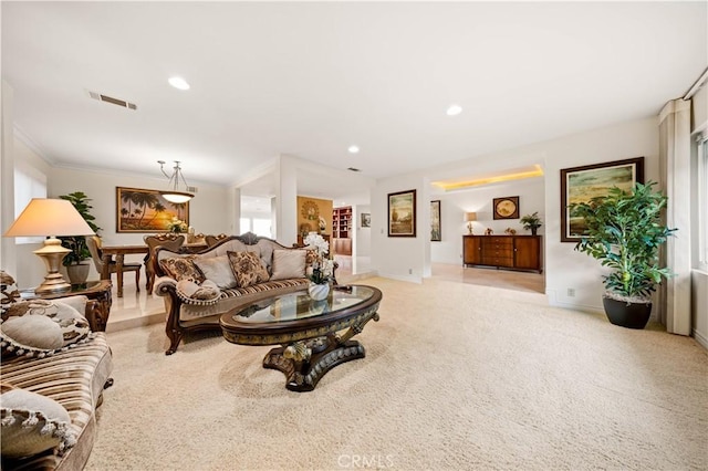 living area with ornamental molding, recessed lighting, light colored carpet, and baseboards