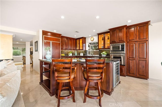 kitchen featuring wine cooler, stainless steel appliances, backsplash, glass insert cabinets, and a kitchen island