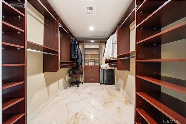 walk in closet featuring attic access, marble finish floor, and visible vents