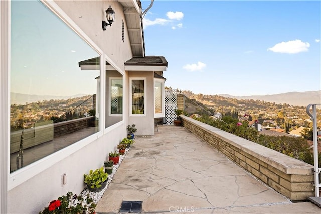 balcony featuring a patio area and a mountain view