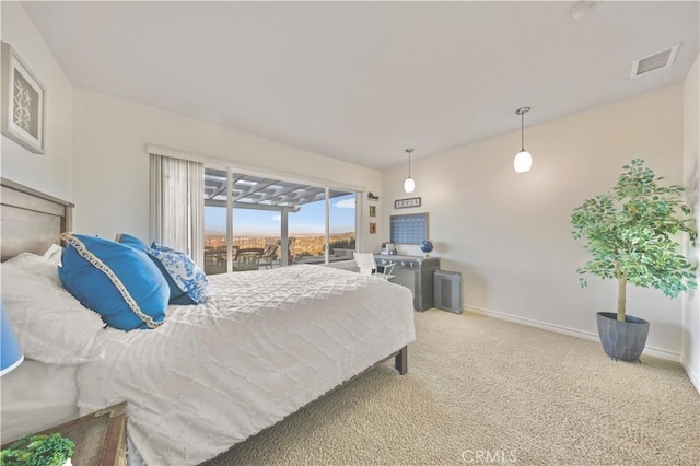 carpeted bedroom featuring access to outside, visible vents, and baseboards