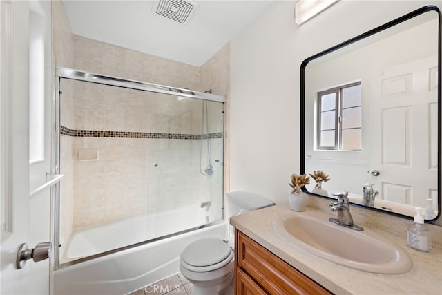 bathroom with toilet, enclosed tub / shower combo, visible vents, and vanity