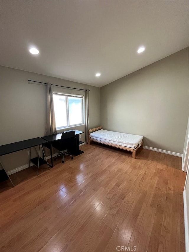 bedroom with recessed lighting, baseboards, and light wood finished floors