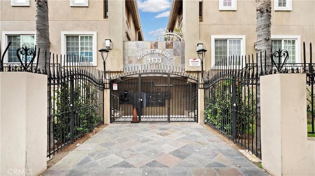 view of gate featuring a fenced front yard