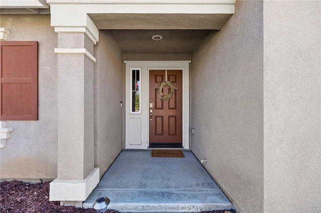 doorway to property with stucco siding