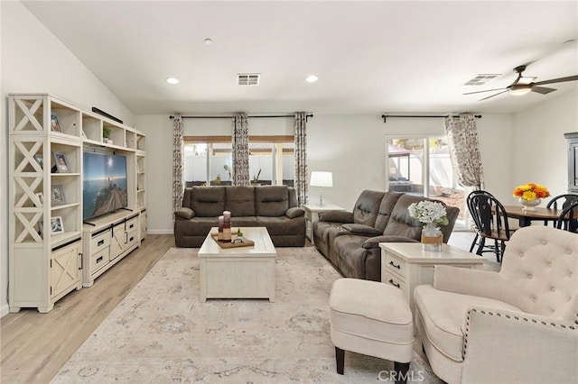 living room with light wood finished floors, a ceiling fan, visible vents, and recessed lighting