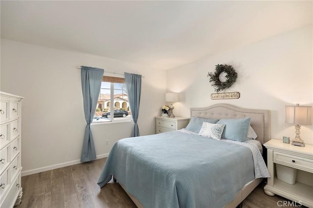 bedroom featuring dark wood-style floors and baseboards