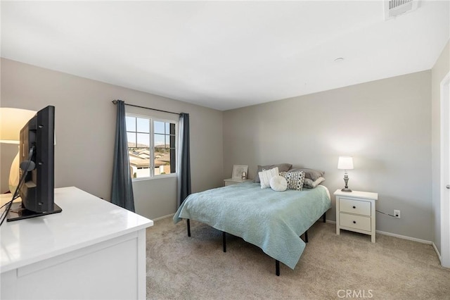 bedroom with baseboards, visible vents, and light colored carpet