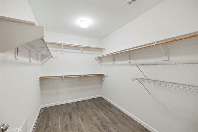 walk in closet with dark wood-style floors and visible vents