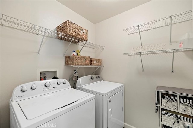 clothes washing area with laundry area and independent washer and dryer