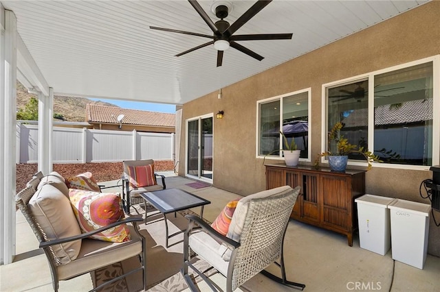 view of patio featuring fence and ceiling fan