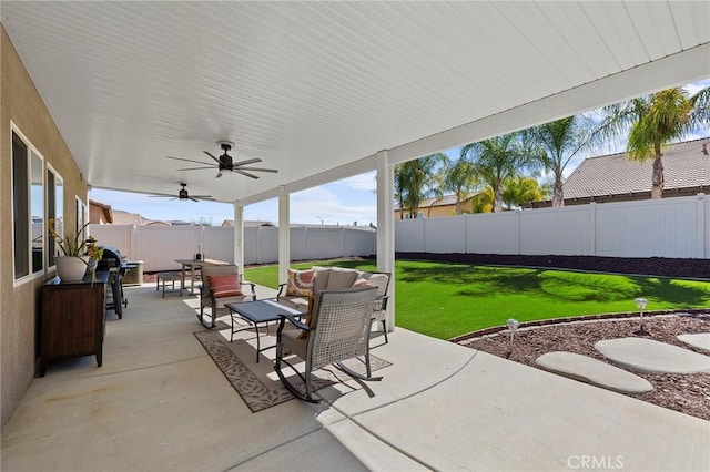 view of patio featuring a fenced backyard, outdoor lounge area, a ceiling fan, and outdoor dining space