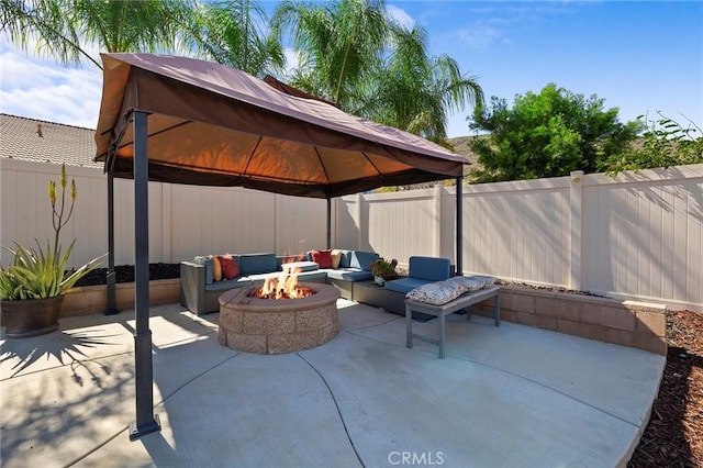 view of patio / terrace with a gazebo, a fenced backyard, and an outdoor living space with a fire pit