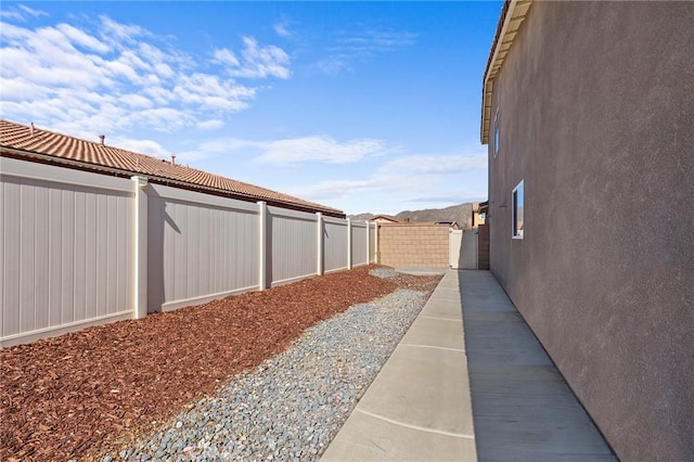 view of yard featuring a patio and a fenced backyard