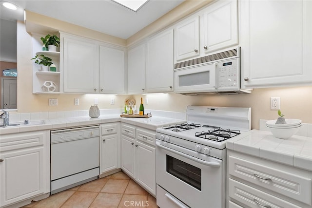 kitchen with open shelves, white appliances, tile counters, and white cabinets