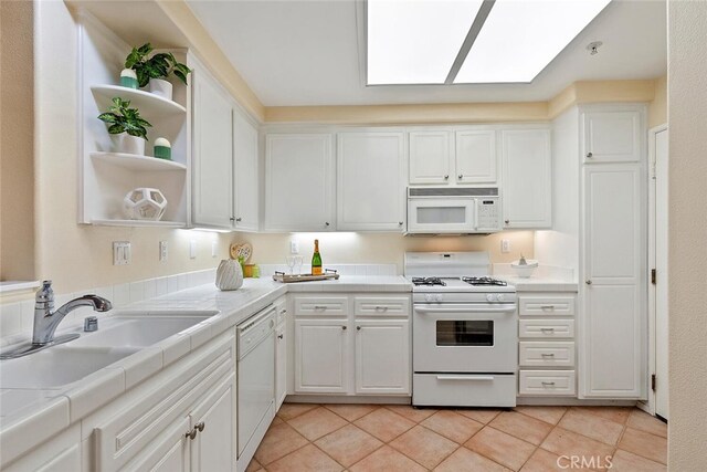 1703 Solvay Aisle Unit 106, Irvine, CA 92606 - kitchen featuring white appliances, tile counters, white cabinetry, and light tile patterned floors
