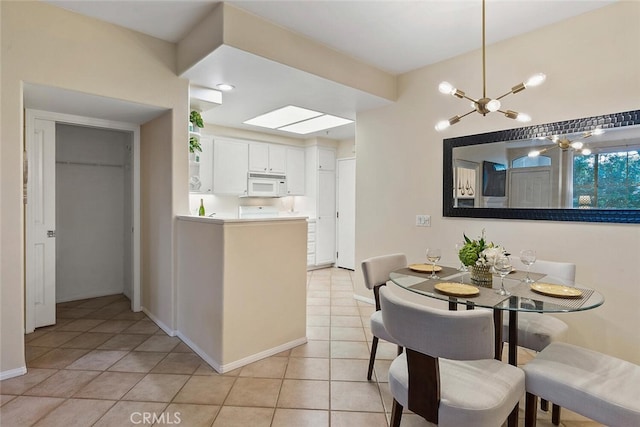 1703 Solvay Aisle Unit 106, Irvine, CA 92606 - dining space featuring light tile patterned floors and a chandelier