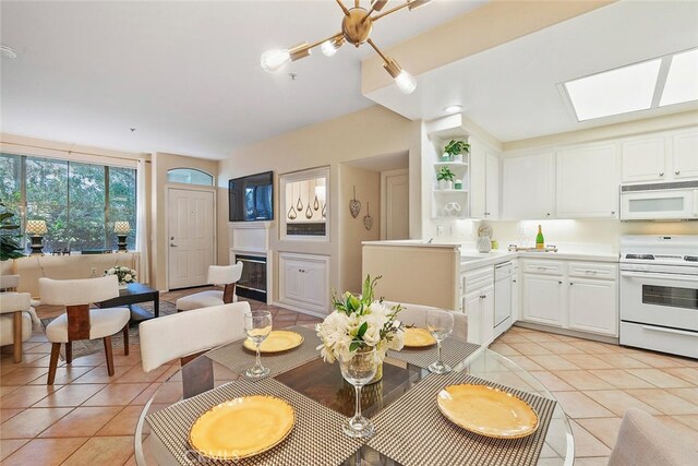 1703 Solvay Aisle Unit 106, Irvine, CA 92606 - dining room featuring light tile patterned floors and a skylight