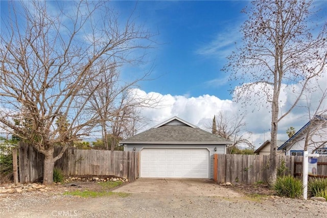 detached garage featuring fence