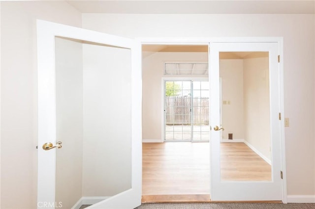 entryway with french doors and baseboards