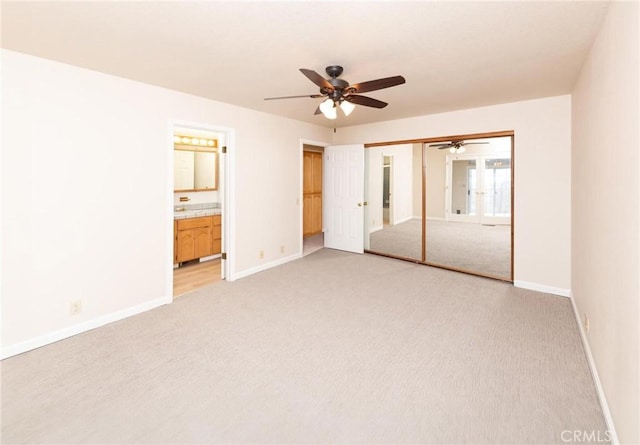 unfurnished bedroom with carpet floors, baseboards, a closet, and french doors