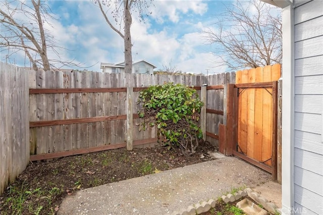 view of yard featuring fence and a gate