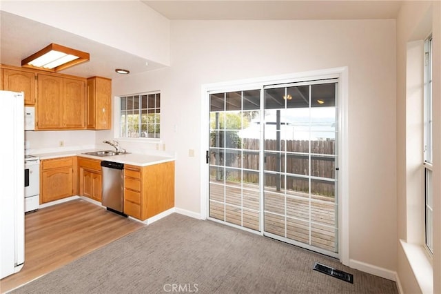 kitchen featuring light countertops, visible vents, stainless steel dishwasher, stove, and a sink