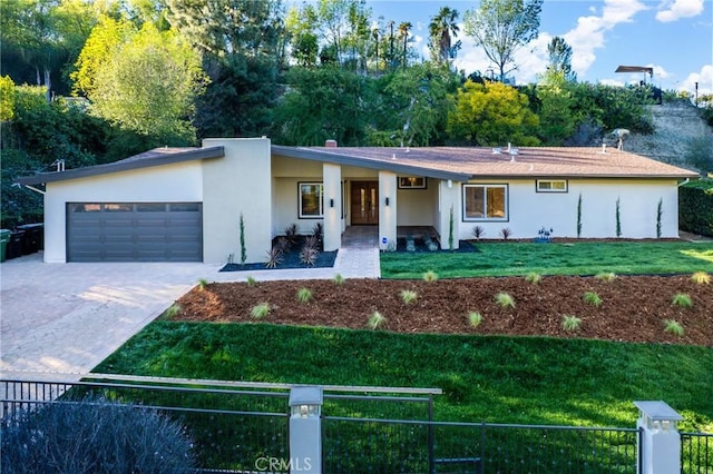 single story home featuring a garage, driveway, stucco siding, fence, and a front yard